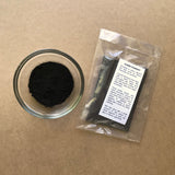 Packaged bag of Black Iron Oxide Pigment with bowl of pigment powder