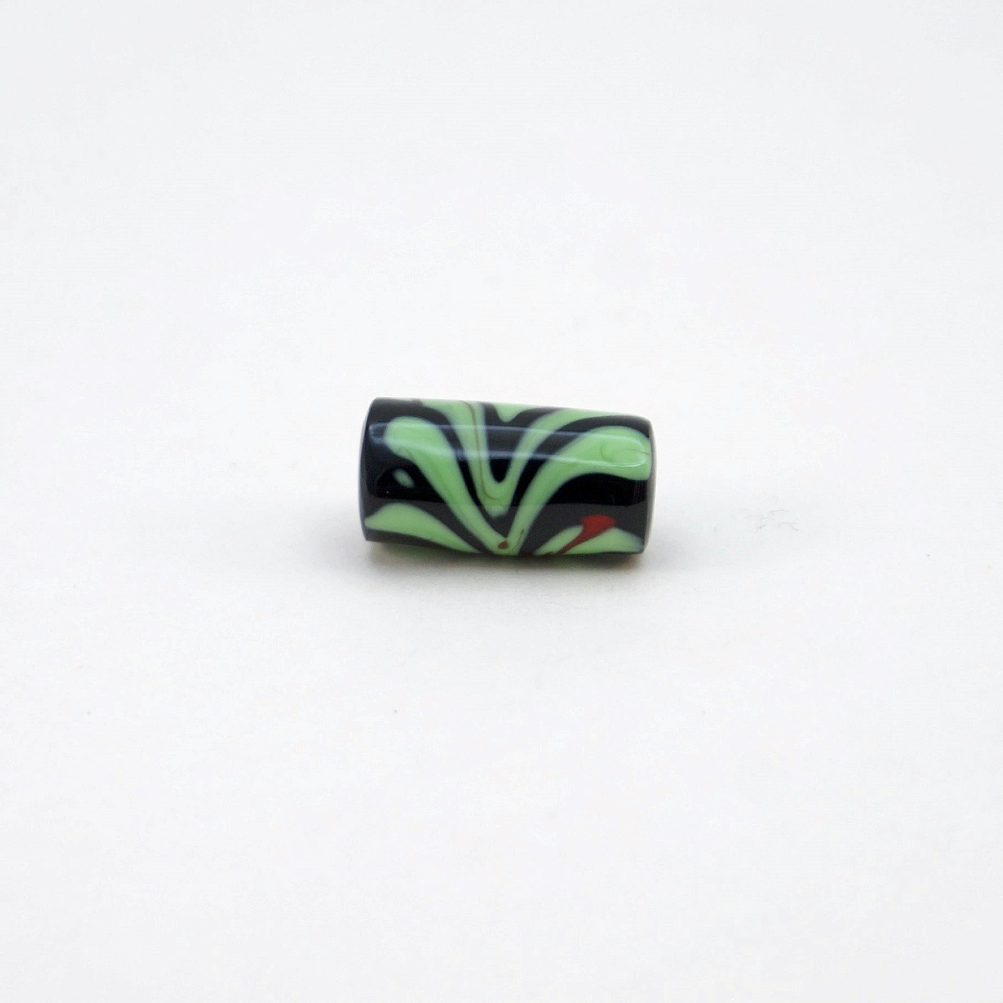 Lampwork glass bead with black background, light green leaves & red flower stalk