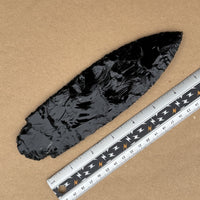 reverse of large black obsidian spearhead