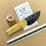 Black obsidian blade knife kit with Osage orange handle on a brown background, accompanied by a ruler for scale.