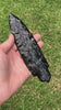 oversize black obsidian lance blade rotating in hand
