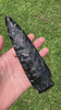 oversize black obsidian knife blade rotating in hand