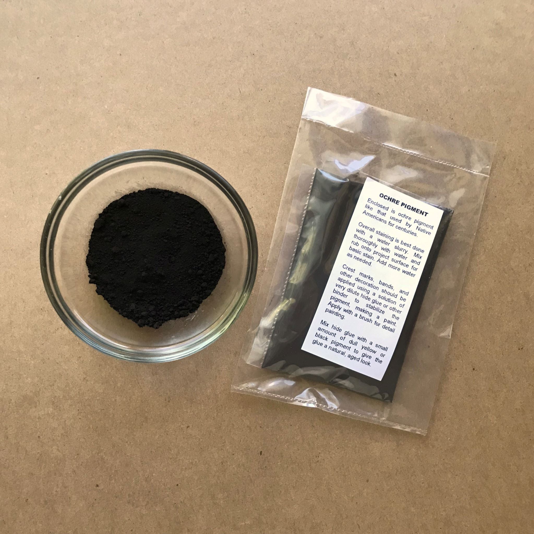 Packaged bag of Black Iron Oxide Pigment with bowl of pigment powder