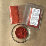 Packaged Bright Red Ochre Pigment with bowl of powdered pigment