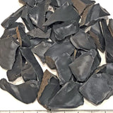 Group of dacite rock tumbling rough material spalls