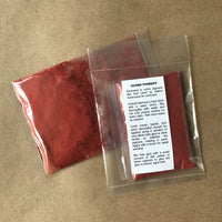 Packaged dull red ochre powdered pigment with instructions