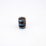 Lampwork glass tube bead on end with bright colors on black core