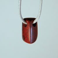 Front view of red jasper triangle bead