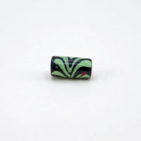 Lampwork glass bead with black background, light green leaves & red flower stalk