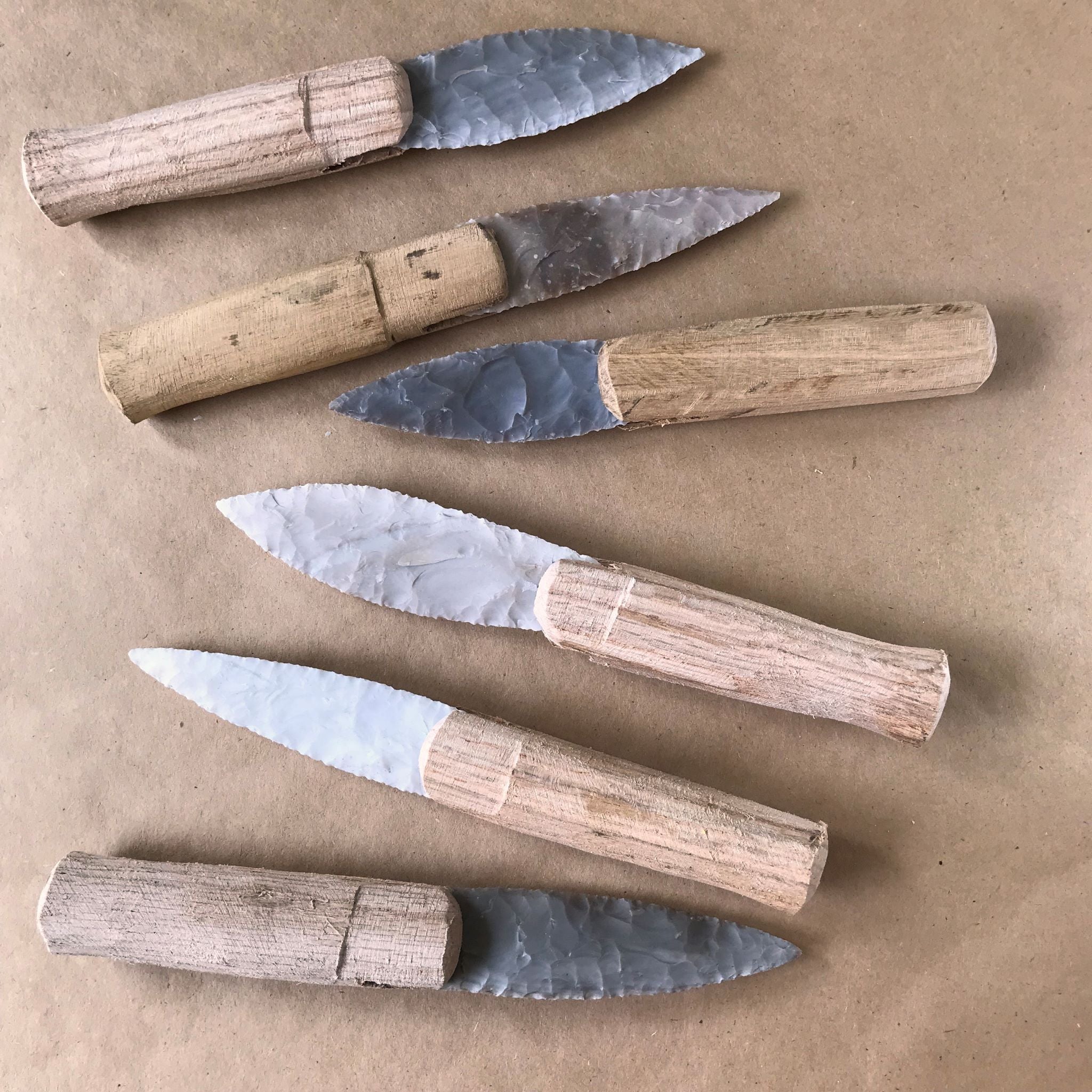 6 examples of Paleo style knife blades with wooden handles