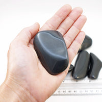 Dacite tumbled palm stone in hand