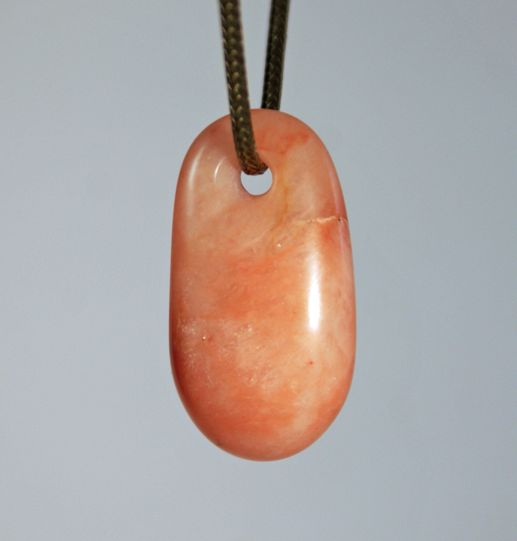 Rose quartz stone oblong pendant on braided cord