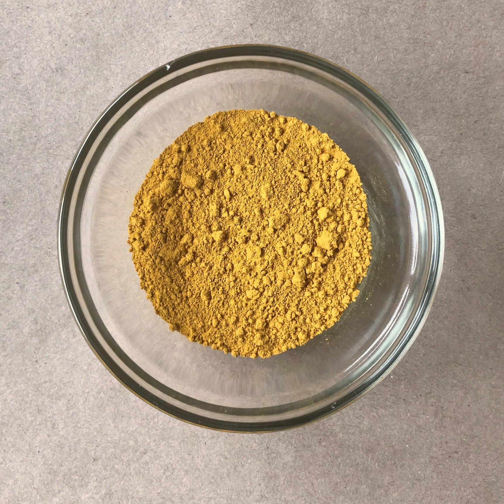Powdered yellow ochre in bowl